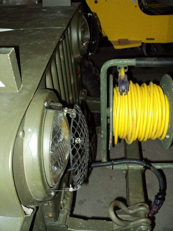 Extension cord spool mounted on front bumper