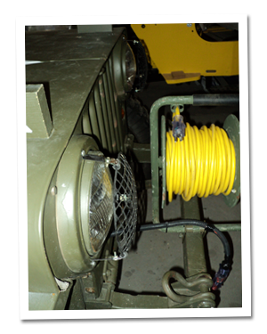 Extension cord spool mounted on front bumper
