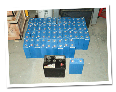 Old golf cart battery in from of the new lithium ion batteries